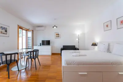 a bedroom with a bed and a table and chairs at FLH Funchal Studio with Balcony in Funchal