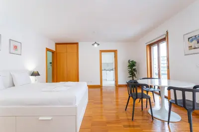 a bedroom with a bed and a table and chairs at FLH Funchal Studio with Balcony in Funchal