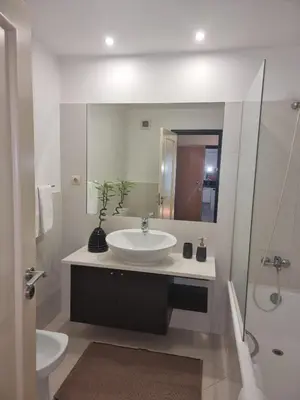 a white bathroom with a sink and a mirror at Magical Seaview (Free Parking) in Funchal