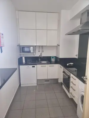 a white kitchen with white cabinets and a sink at Magical Seaview (Free Parking) in Funchal