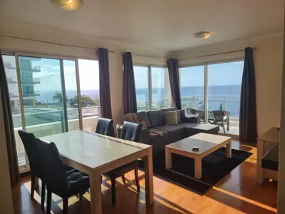 a living room with a couch and a table at Magical Seaview (Free Parking) in Funchal