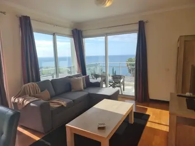 a living room with a couch and a table at Magical Seaview (Free Parking) in Funchal