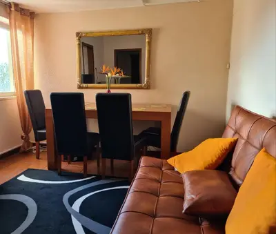 a living room with a couch and a table with a mirror at Machico Beach Comfort in Machico