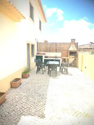 a patio with a table and chairs and a piano at Porto Santo Casa Dourada in Porto Santo