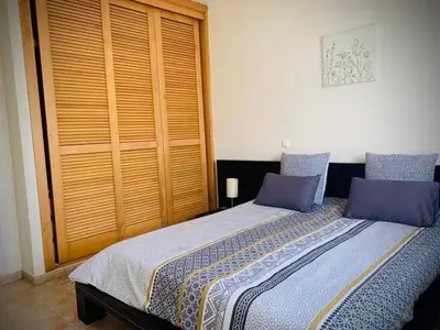 a bedroom with a large bed with purple pillows at Porto Santo Casa Dourada in Porto Santo