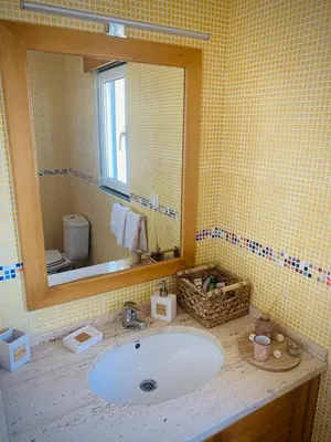a bathroom with a sink and a mirror at Porto Santo Casa Dourada in Porto Santo