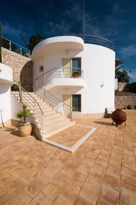 a white building with stairs in front of it at Beach Park Apartments in Luz
