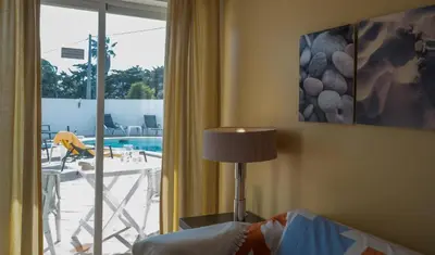 a bedroom with a window with a view of a pool at Beach Park Apartments in Luz