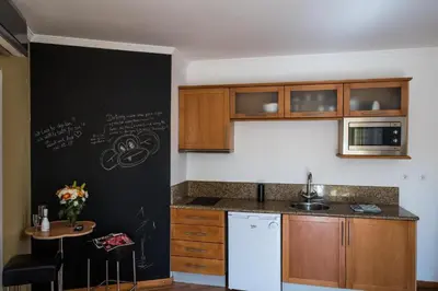 a kitchen with a black chalkboard on the wall at Beach Park Apartments in Luz