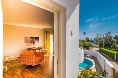 a living room with a view of a pool at Beach Park Apartments in Luz