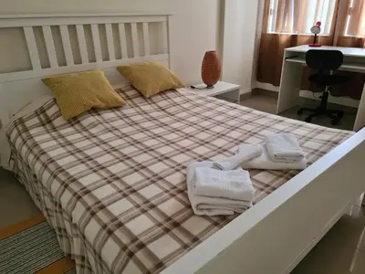 a bedroom with a bed with towels on it at Funchal Centre Comfort in Funchal