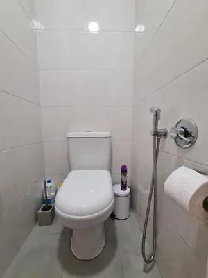 a white bathroom with a toilet and a shower at Funchal Centre Comfort in Funchal