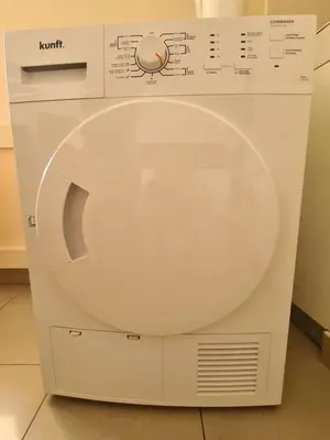 a white washing machine sitting in a room at Funchal Centre Comfort in Funchal