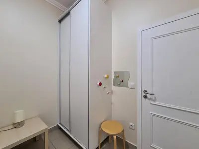 a room with a door and a chair and a refrigerator at Funchal Centre Comfort in Funchal