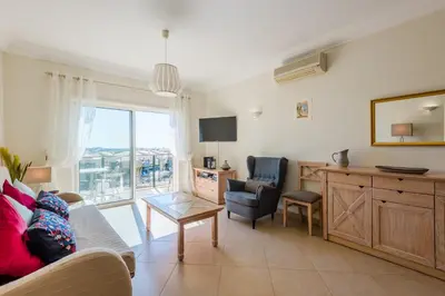 a living room with a couch and a chair at Casa Ocean Golf - Boavista Resort in Lagos