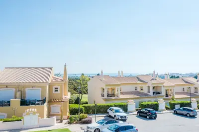 a row of houses with cars parked in a parking lot at Casa Ocean Golf - Boavista Resort in Lagos