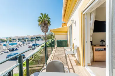 a balcony with chairs and a view of a street at Casa Ocean Golf - Boavista Resort in Lagos