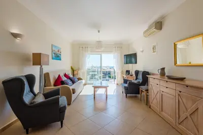 a living room with a couch and chairs and a table at Casa Ocean Golf - Boavista Resort in Lagos