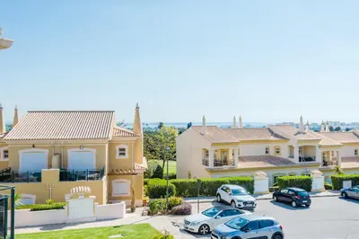 a row of houses with cars parked in a parking lot at Casa Ocean Golf - Boavista Resort in Lagos