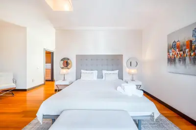 a white bedroom with two beds and two lamps at Villa Vacuna by Amazing Madeira in Funchal