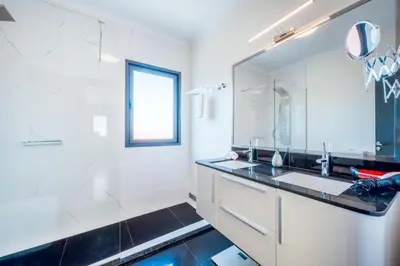 a bathroom with a sink and a mirror at Villa Vacuna by Amazing Madeira in Funchal