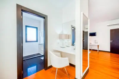 a room with a white table and a white chair at Villa Vacuna by Amazing Madeira in Funchal