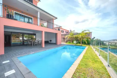 a swimming pool in the backyard of a house at Villa Vacuna by Amazing Madeira in Funchal