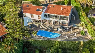 an overhead view of a house with a swimming pool at Vila Crerital - By Wehost in São Gonçalo