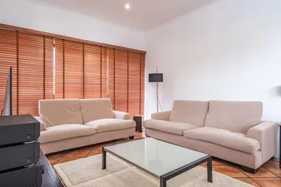 a living room with two couches and a coffee table at Vila Crerital - By Wehost in São Gonçalo