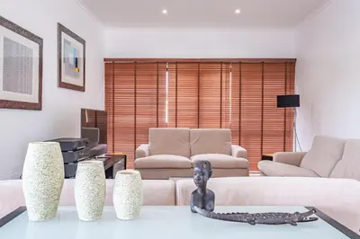 a living room with a couch and a table at Vila Crerital - By Wehost in São Gonçalo