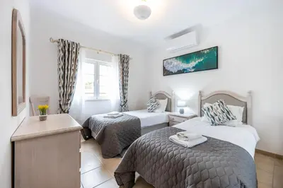 a hotel room with two beds and a window at Casa Ensolarada in Budens