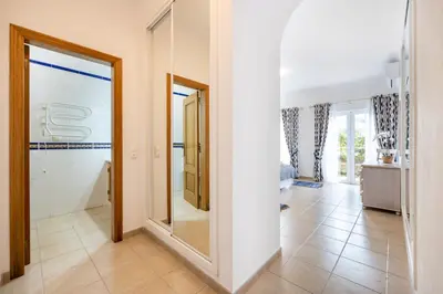 a hallway with a mirror and a bathroom at Casa Ensolarada in Budens