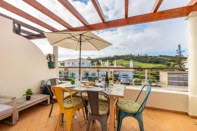 a dining room with a table and chairs at Casa Ensolarada in Budens