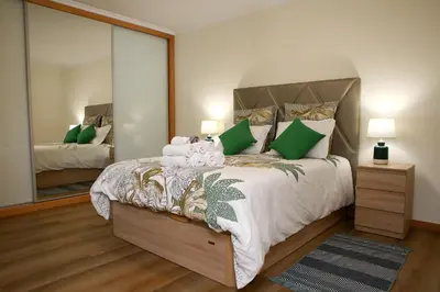 a bedroom with a bed with a large mirror at Torrinha & Sá in Funchal