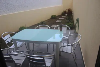 a table and chairs with a blue table and chairs at Torrinha & Sá in Funchal