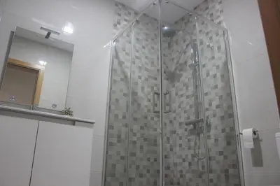 a shower with a glass door in a bathroom at Torrinha & Sá in Funchal