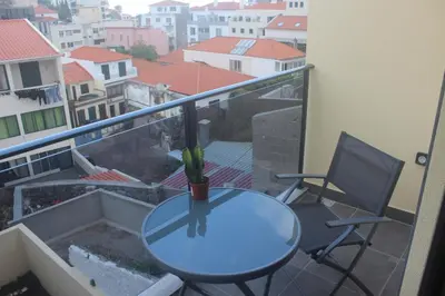 a table and two chairs on a balcony with a view at Torrinha & Sá in Funchal