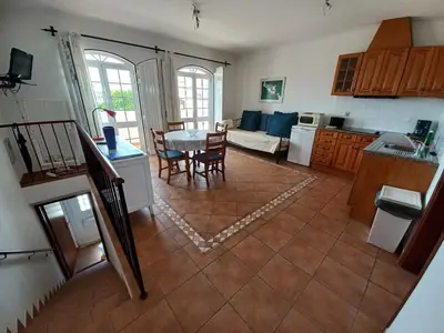 a kitchen and living room with a table and chairs at Cool Villas T1 in Sagres