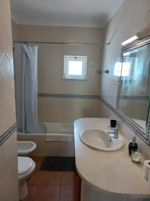 a bathroom with a sink and a toilet and a mirror at Cool Villas T1 in Sagres