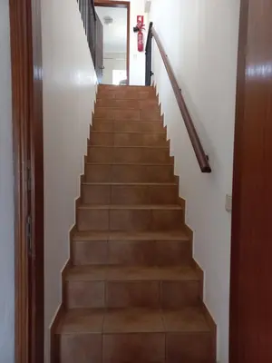 a stairway with wooden stairs and a wooden rail at Cool Villas T1 in Sagres