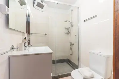 a bathroom with a shower and a sink and a toilet at Avelino Apartment by Atlantic Holiday in Machico