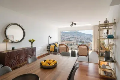 a living room with a table with a bowl of oranges on it at Casa do Castelo by An Island Apart in Funchal
