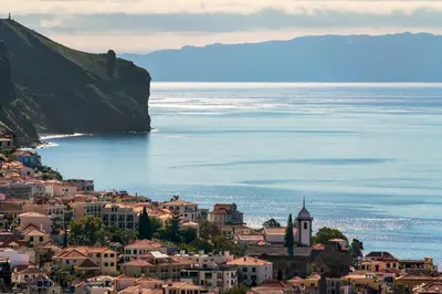 a town on a hill next to the ocean at Casa do Castelo by An Island Apart in Funchal