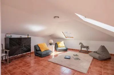 a living room with couches and a tv in a attic at Casa do Castelo by An Island Apart in Funchal