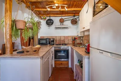 a kitchen with white cabinets and a counter top at Casa da Praia 1 in Budens