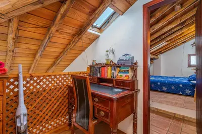 an attic room with a desk and a bed at Casa da Praia 1 in Budens