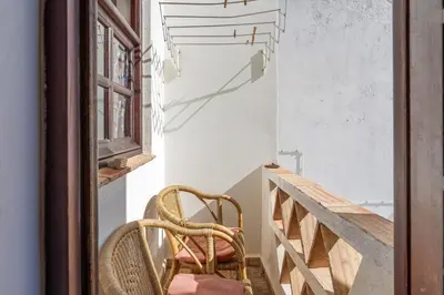a pair of chairs sitting on the stairs of a house at Casa da Praia 1 in Budens
