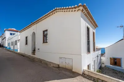 a white building on the side of a street at Casa da Praia 1 in Budens