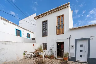 a white house with a patio in front of it at Casa da Praia 2 in Budens