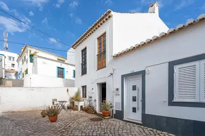 a white house with a courtyard in front of it at Casa da Praia 2 in Budens